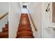 Classic wooden staircase with simple handrail at 608 Armada S Rd, Venice, FL 34285
