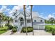 Two-story home with white siding, gray roof, and a three-car garage at 2118 Harbour Watch Dr, Tarpon Springs, FL 34689