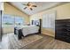 Bright bedroom with a queen-size bed, dresser, and view at 2118 Harbour Watch Dr, Tarpon Springs, FL 34689