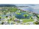 An aerial view of a waterfront community, showcasing lakefront homes and lush landscaping at 2118 Harbour Watch Dr, Tarpon Springs, FL 34689