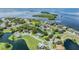 Breathtaking aerial view showcasing the community's waterfront homes and beautiful landscaping near the water at 2118 Harbour Watch Dr, Tarpon Springs, FL 34689