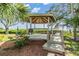 Wooden gazebo with steps leading down to a dock at 2118 Harbour Watch Dr, Tarpon Springs, FL 34689