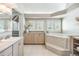 Elegant bathroom with soaking tub, double vanity, and large windows at 2118 Harbour Watch Dr, Tarpon Springs, FL 34689