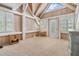 Bright bonus room with wood-beamed ceiling, window, and door at 2118 Harbour Watch Dr, Tarpon Springs, FL 34689