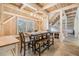 Bright dining area featuring a wooden table, bench seating, and natural light from large windows at 2118 Harbour Watch Dr, Tarpon Springs, FL 34689