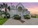 Stately two-story home with a grand entrance, well-manicured landscaping, and a welcoming front porch at 2118 Harbour Watch Dr, Tarpon Springs, FL 34689