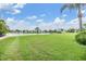 Expansive grassy backyard with lake views and lush landscaping at 2118 Harbour Watch Dr, Tarpon Springs, FL 34689