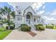 Two-story home with white siding, gray roof, and a large driveway at 2118 Harbour Watch Dr, Tarpon Springs, FL 34689