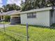 Light green house with carport and fence at 2411 E Linsey St # Street, Tampa, FL 33605