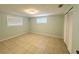 Bright bedroom featuring tiled floors, closet, and multiple windows with blinds at 7246 Dianne Dr, New Port Richey, FL 34652