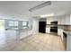 Bright kitchen view features granite countertops, white cabinetry, and stainless steel appliances at 7246 Dianne Dr, New Port Richey, FL 34652