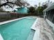 Beautiful pool with tile and brick patio is surrounded by new black fencing at 7246 Dianne Dr, New Port Richey, FL 34652