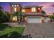 Two-story house with orange exterior, white garage doors, and paver driveway at 404 Bahama Grande Blvd, Apollo Beach, FL 33572