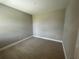 Simple bedroom with light walls and wood-look tile floors at 3707 Nandina Cir, Sun City Center, FL 33573