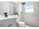 Modern bathroom with marble shower and gray vanity at 811 27Th Street E Ct, Bradenton, FL 34208