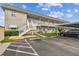 Front view of a light brick building with parking and stairs at 5357 81St N St # 1, St Petersburg, FL 33709