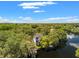 Aerial view of a modern home nestled in lush greenery with waterfront access at 321 W Hanlon St, Tampa, FL 33604