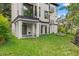 Lush backyard with covered patio, and a modern home exterior, ideal for relaxation and entertaining at 321 W Hanlon St, Tampa, FL 33604