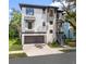 Contemporary two-story home features a two-car garage and well-manicured landscaping at 321 W Hanlon St, Tampa, FL 33604