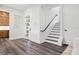 Bright foyer with wood floors, staircase with black rails, and modern front door at 321 W Hanlon St, Tampa, FL 33604