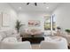 Comfortable living room showcasing stylish furniture, neutral tones, and natural light from a large window at 321 W Hanlon St, Tampa, FL 33604