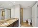 Elegant bathroom with double sinks, granite countertop, and a glass shower at 450 Knights Run Ave # 411, Tampa, FL 33602