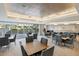 Bright and airy common area with tables and chairs for residents at 450 Knights Run Ave # 411, Tampa, FL 33602