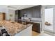 Modern kitchen with dark wood cabinets, granite counters, and stainless steel appliances at 450 Knights Run Ave # 411, Tampa, FL 33602