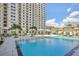 Resort-style pool with lounge chairs and a surrounding building at 450 Knights Run Ave # 411, Tampa, FL 33602
