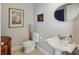 Stylish powder room with pedestal sink and decorative artwork at 450 Knights Run Ave # 411, Tampa, FL 33602