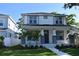 Charming two-story home featuring a welcoming front porch with decorative columns and lush landscaping at 759 48Th N Ave, St Petersburg, FL 33703
