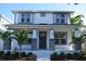 Charming two-story home featuring a welcoming front porch with decorative columns and lush landscaping at 759 48Th N Ave, St Petersburg, FL 33703