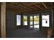 Unfinished interior space showcasing framework, windows, and a door leading to the backyard at 759 48Th N Ave, St Petersburg, FL 33703