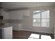Modern kitchen featuring white cabinetry, hardwood floors, and a bright window at 759 48Th N Ave, St Petersburg, FL 33703