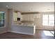 Open-concept kitchen featuring white cabinets, a breakfast bar, and stainless steel appliances at 759 48Th N Ave, St Petersburg, FL 33703