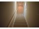Well lit staircase with neutral walls and tile steps leading to the upper level at 759 48Th N Ave, St Petersburg, FL 33703