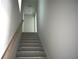 Interior stairway showing tile steps and a simple wooden handrail leading to the upper level at 759 48Th N Ave, St Petersburg, FL 33703