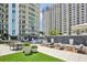Relaxing outdoor patio with seating, modern furniture, and artificial turf at 450 Knights Run Ave # 411, Tampa, FL 33602