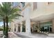 Modern condo building exterior with palm trees and a covered entrance at 450 Knights Run Ave # 411, Tampa, FL 33602