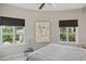 Bedroom with large windows, a bed, and artwork at 450 Knights Run Ave # 411, Tampa, FL 33602