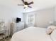 Spacious bedroom with dresser, large bed, and ceiling fan at 10263 Gandy N Blvd # 2416, St Petersburg, FL 33702