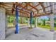 Open carport with a vehicle lift at 13803 E 92 Hwy, Dover, FL 33527