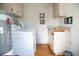 Laundry room with washer, dryer, and overhead cabinets at 2503 W Marquette Ave, Tampa, FL 33614