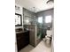 Modern bathroom with a large shower and dark vanity at 2503 W Marquette Ave, Tampa, FL 33614