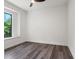 Bright bedroom featuring dark grey vinyl flooring and a large window at 321 W Hanlon St, Tampa, FL 33604