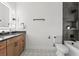 Bathroom features dark tile, wood cabinets and patterned floor at 321 W Hanlon St, Tampa, FL 33604