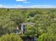Aerial view showcasing a waterfront property in a wooded area at 321 W Hanlon St, Tampa, FL 33604