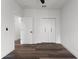 Bright bedroom with dark grey vinyl flooring and double doors to a closet at 321 W Hanlon St, Tampa, FL 33604