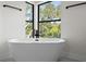 Relaxing bathroom featuring a freestanding tub and large windows at 321 W Hanlon St, Tampa, FL 33604
