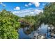 Kayakers paddle along a serene river, with houses nestled amongst trees at 321 W Hanlon St, Tampa, FL 33604